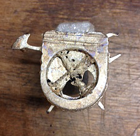 casting silver into a ring using the delft clay method.