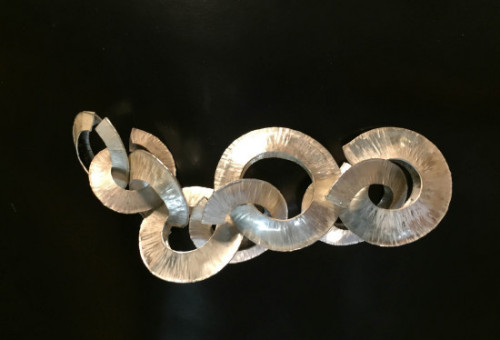 beautiful hammered and folded forms in silver, interlinked to make a necklace