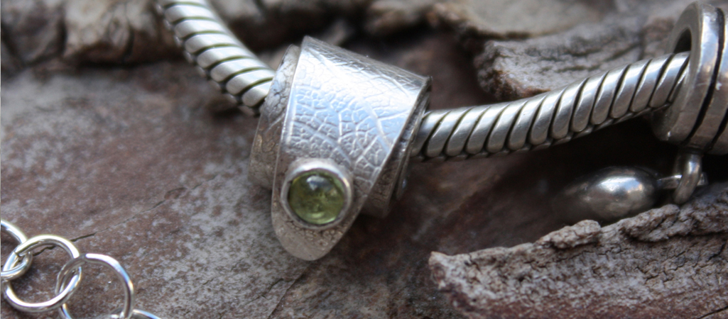 silver charm with peridot, by on of our Flux Jewellery School students